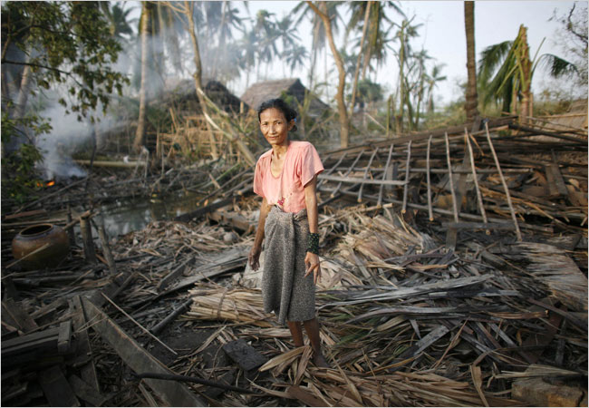 Devastation - A Woman in her cyclone-destroyed house south of Yangon, Myanmar.